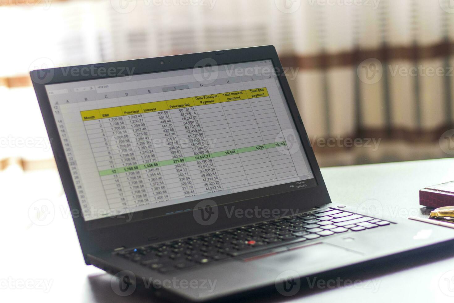 Laptop showing an excel sheet on the screen with bank loan amortization table. Finance photo