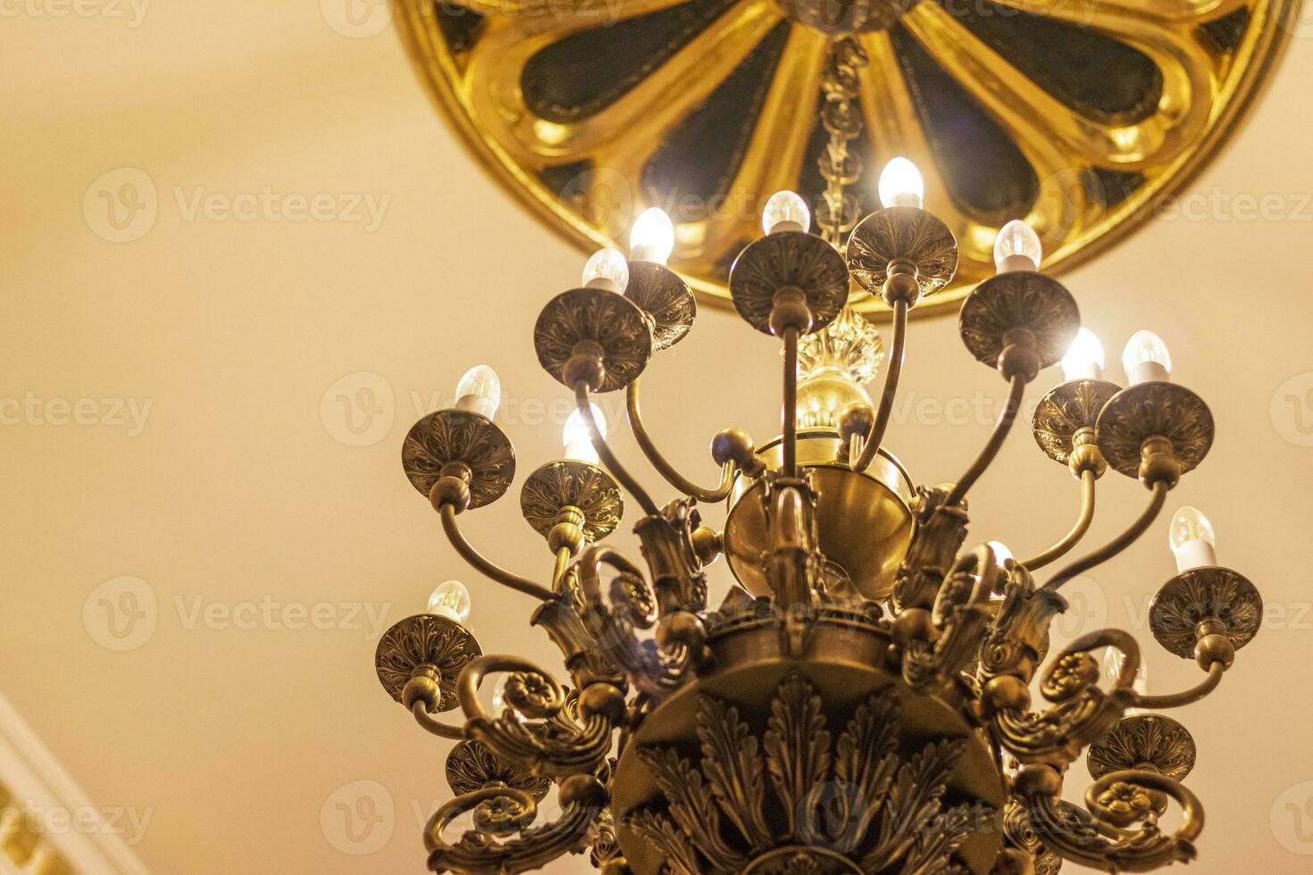 Close up shot of the decorative walls, ceiling and chandelier. Interior photo