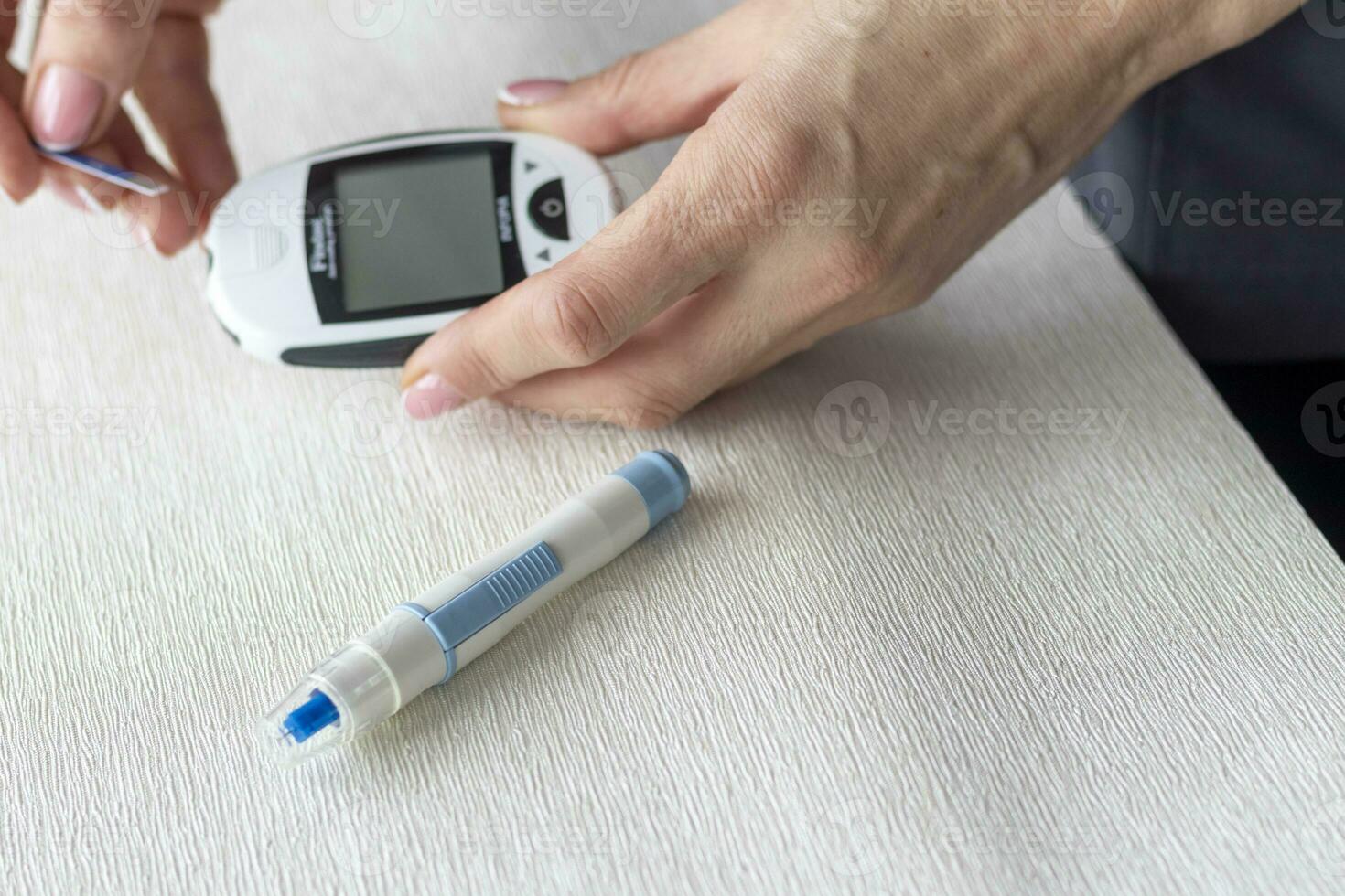 Close up shot of the glucometer instrument on the white surface. Healthcare photo