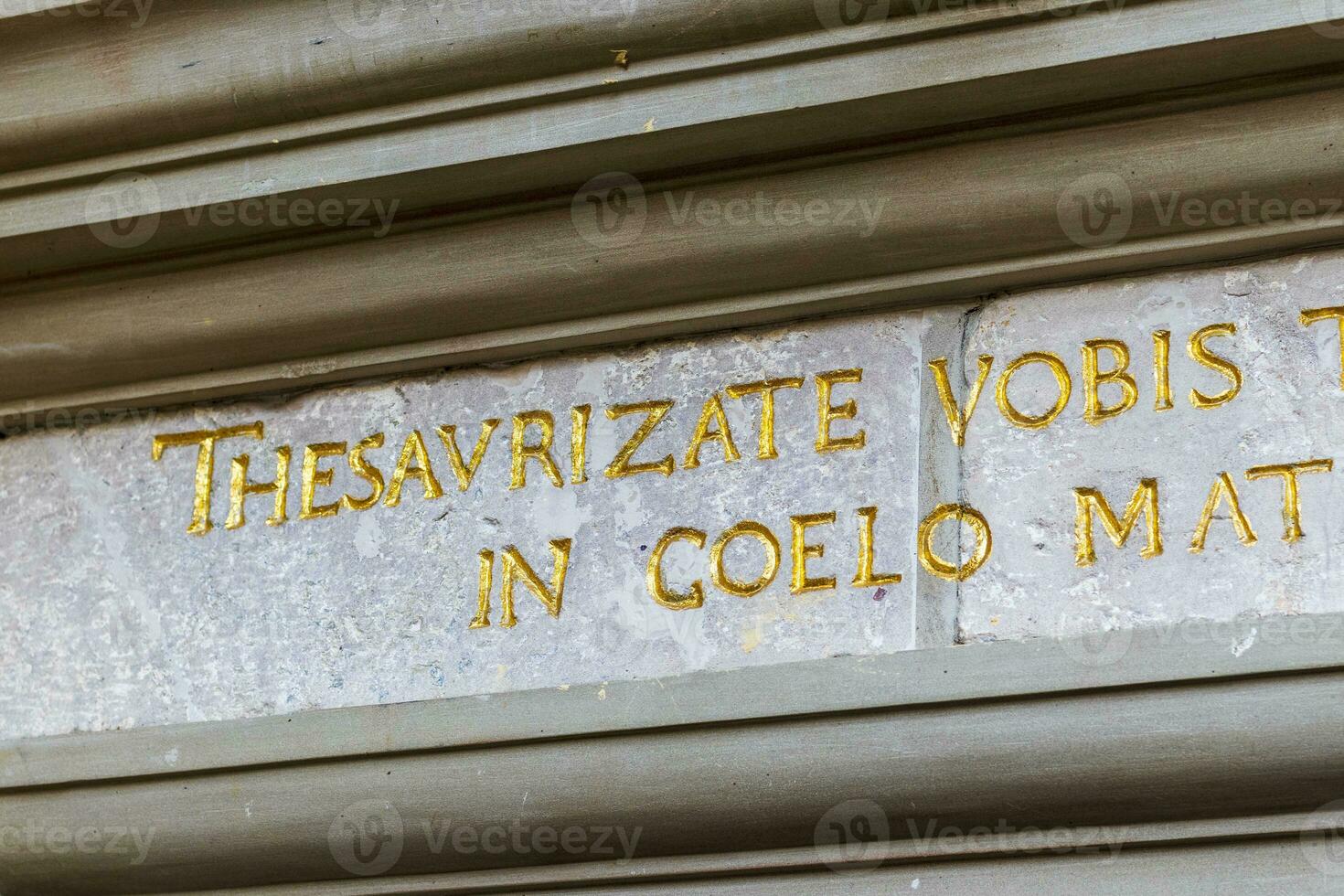 Close up shot of writings on latin language on the facade of the old building photo