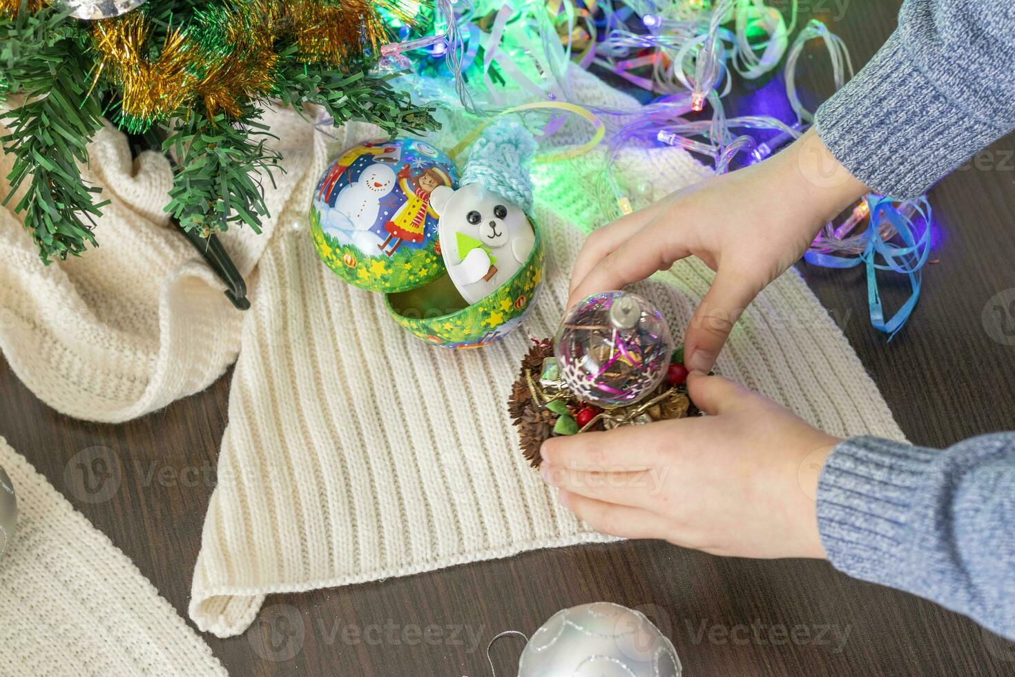 Close up shot of new year decorations. Little boy decorating christmas tree. New year changing numbers. Holiday photo