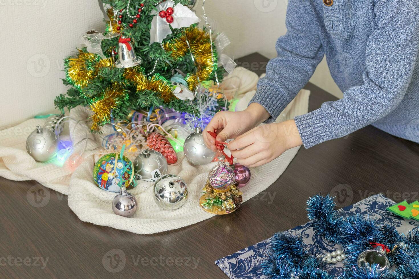 Close up shot of new year decorations. Little boy decorating christmas tree. New year changing numbers. Holiday photo