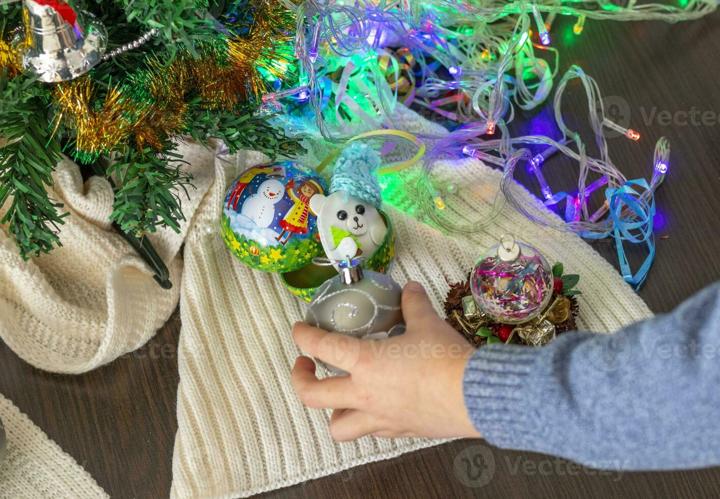 Close up shot of new year decorations. Little boy decorating christmas tree. New year changing numbers. Holiday photo