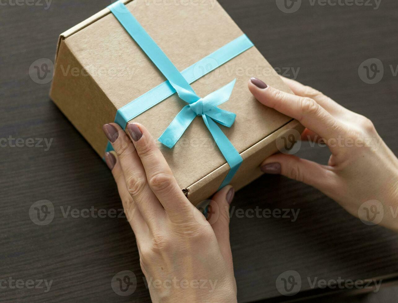 Close up shot of the woman holding rapped gift box. Holiday photo