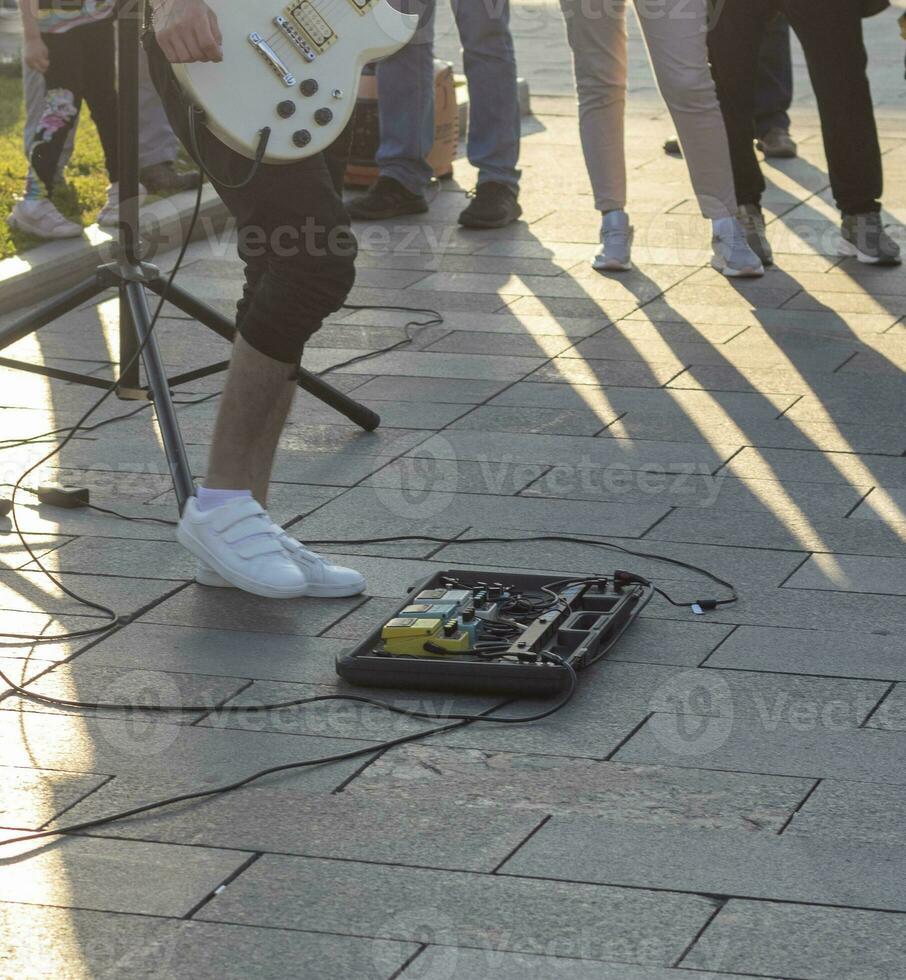 Concept shot of the musical amplifier device being turned on by the mans foot. Performance photo