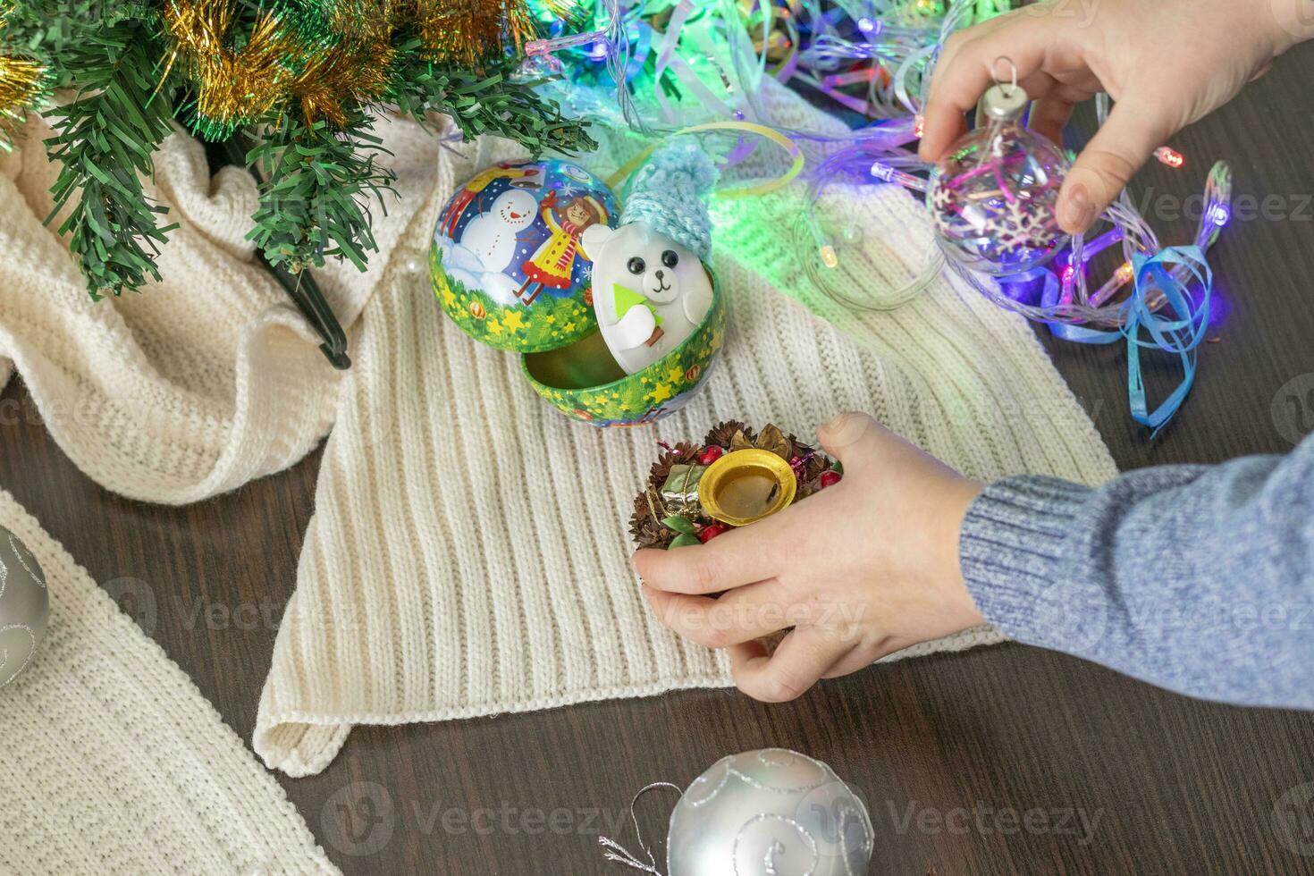 Close up shot of new year decorations. Little boy decorating christmas tree. New year changing numbers. Holiday photo