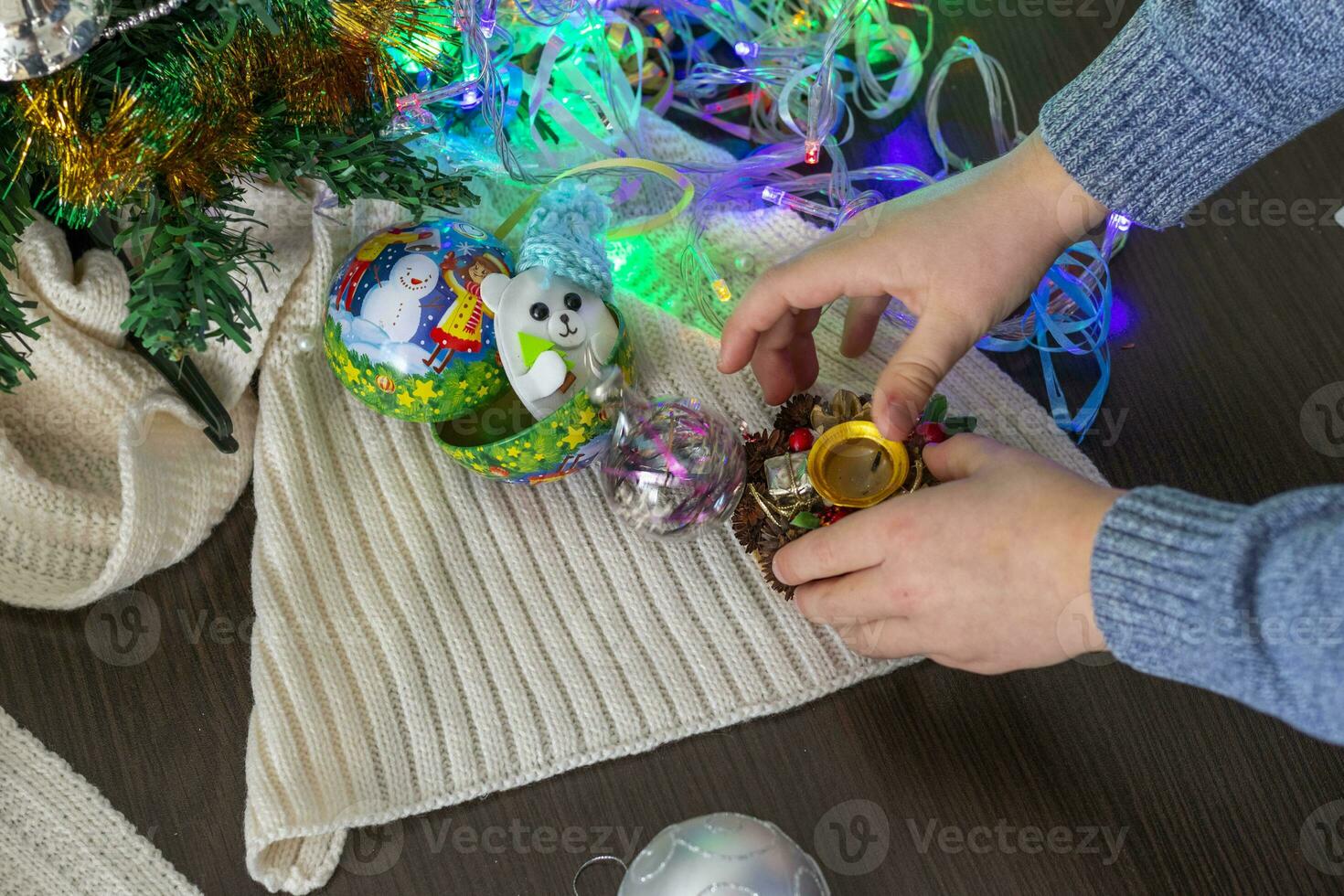 Close up shot of new year decorations. Little boy decorating christmas tree. New year changing numbers. Holiday photo