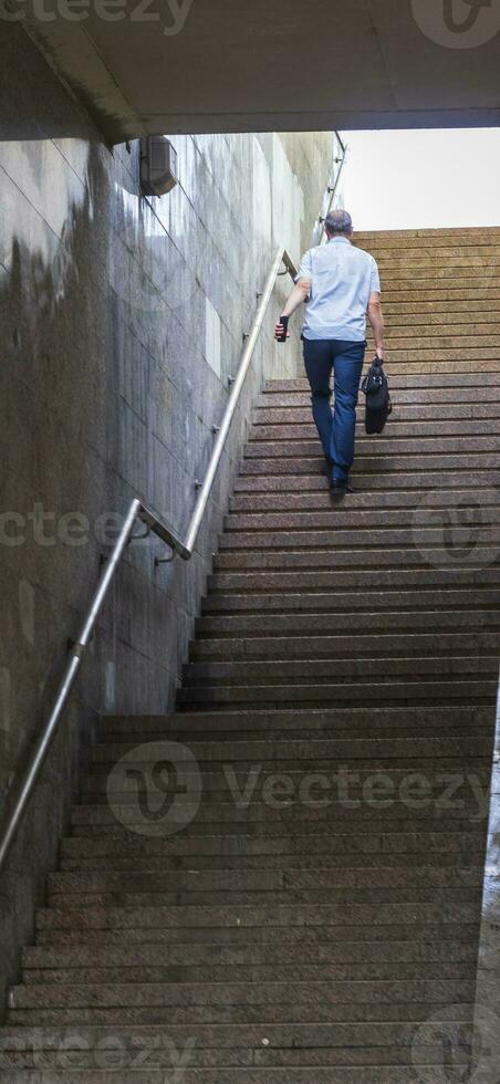 Shot of the man walking up the stairs. Concept photo