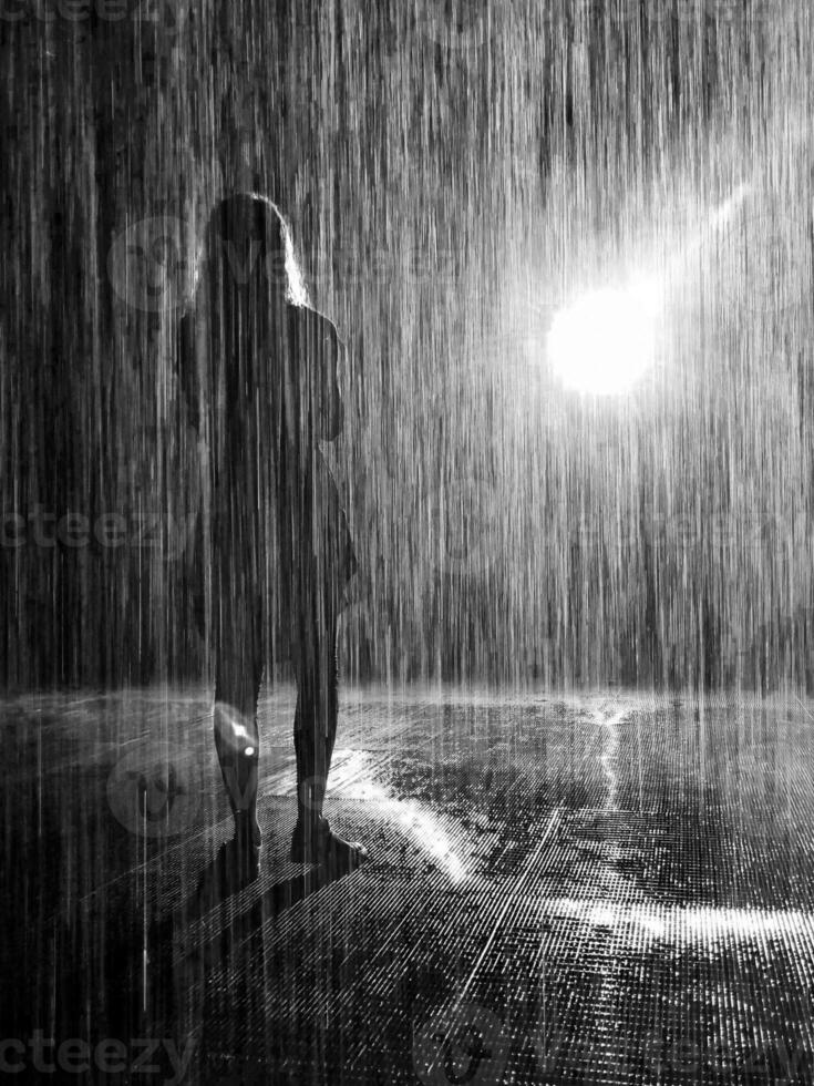 Concept black and white shot of the woman under the pouring rain. Concept photo