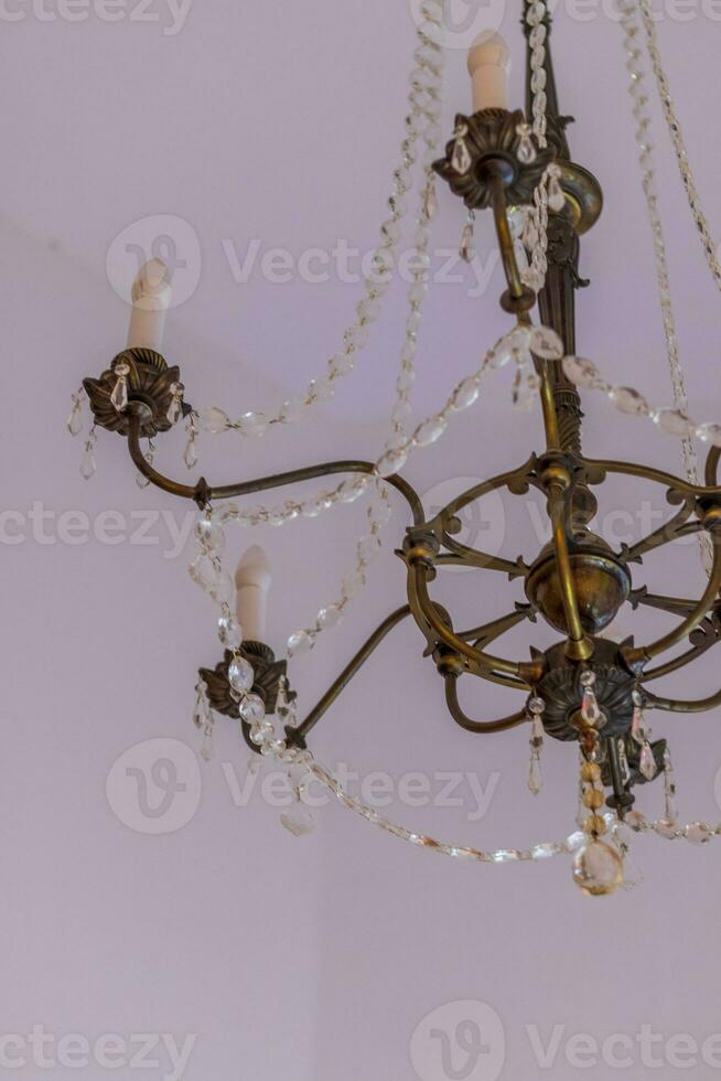 Close up shot of the decorative walls, ceiling and chandelier. Interior photo