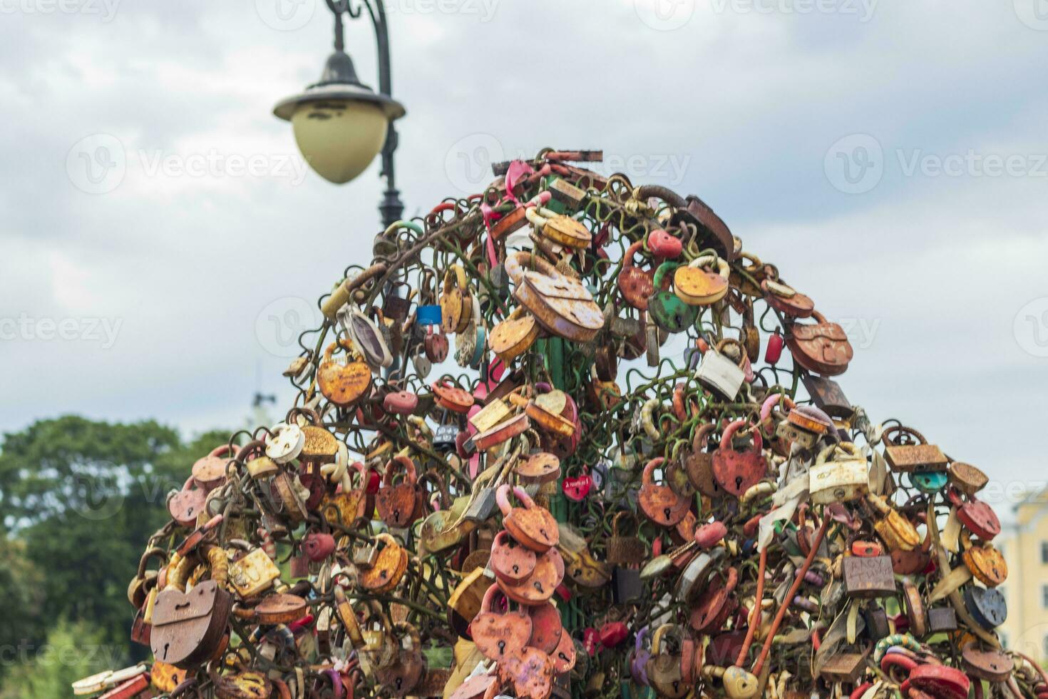 Metal tree structure where couples locking the locks as a sign of true love. Concept photo