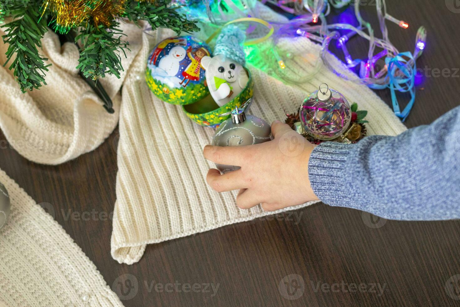 Close up shot of new year decorations. Little boy decorating christmas tree. New year changing numbers. Holiday photo