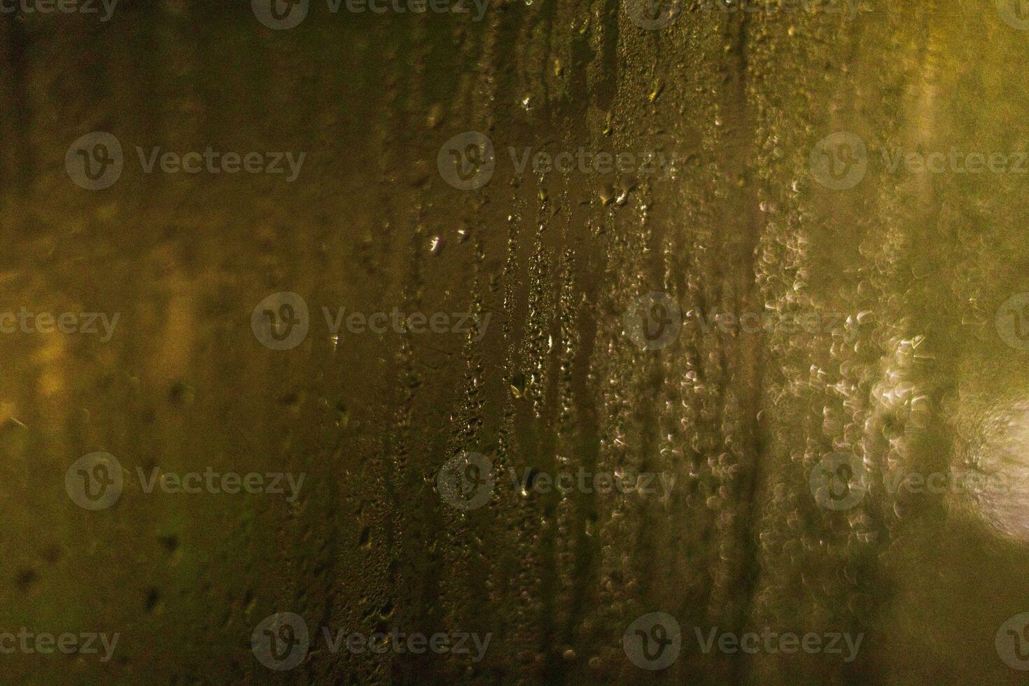 Shot of the window with blurred lights on the background and condensation. Background photo