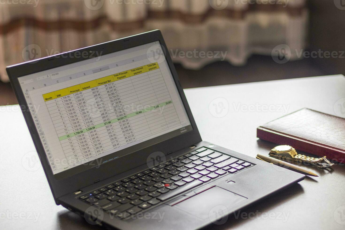 Laptop showing an excel sheet on the screen with bank loan amortization table. Finance photo