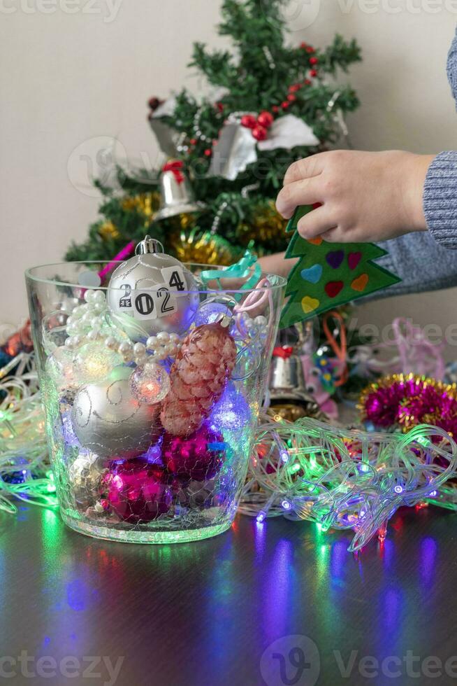 Close up shot of new year decorations. Little boy decorating christmas tree. New year changing numbers. Holiday photo