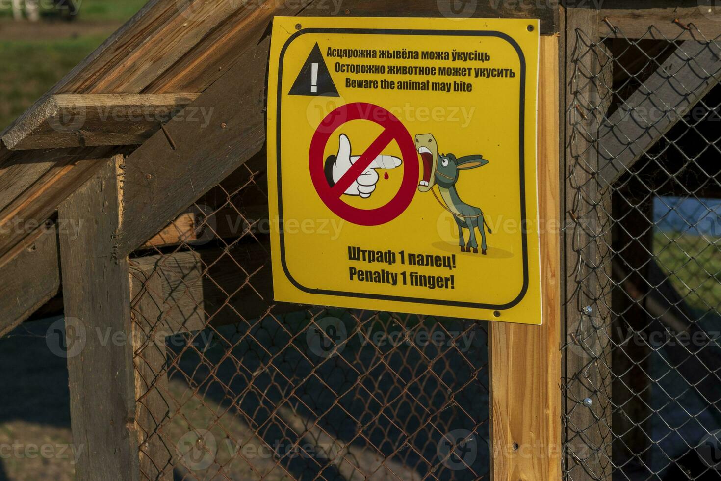 Funny signboard on Belarus and English languages placed in the zoo. Humor photo