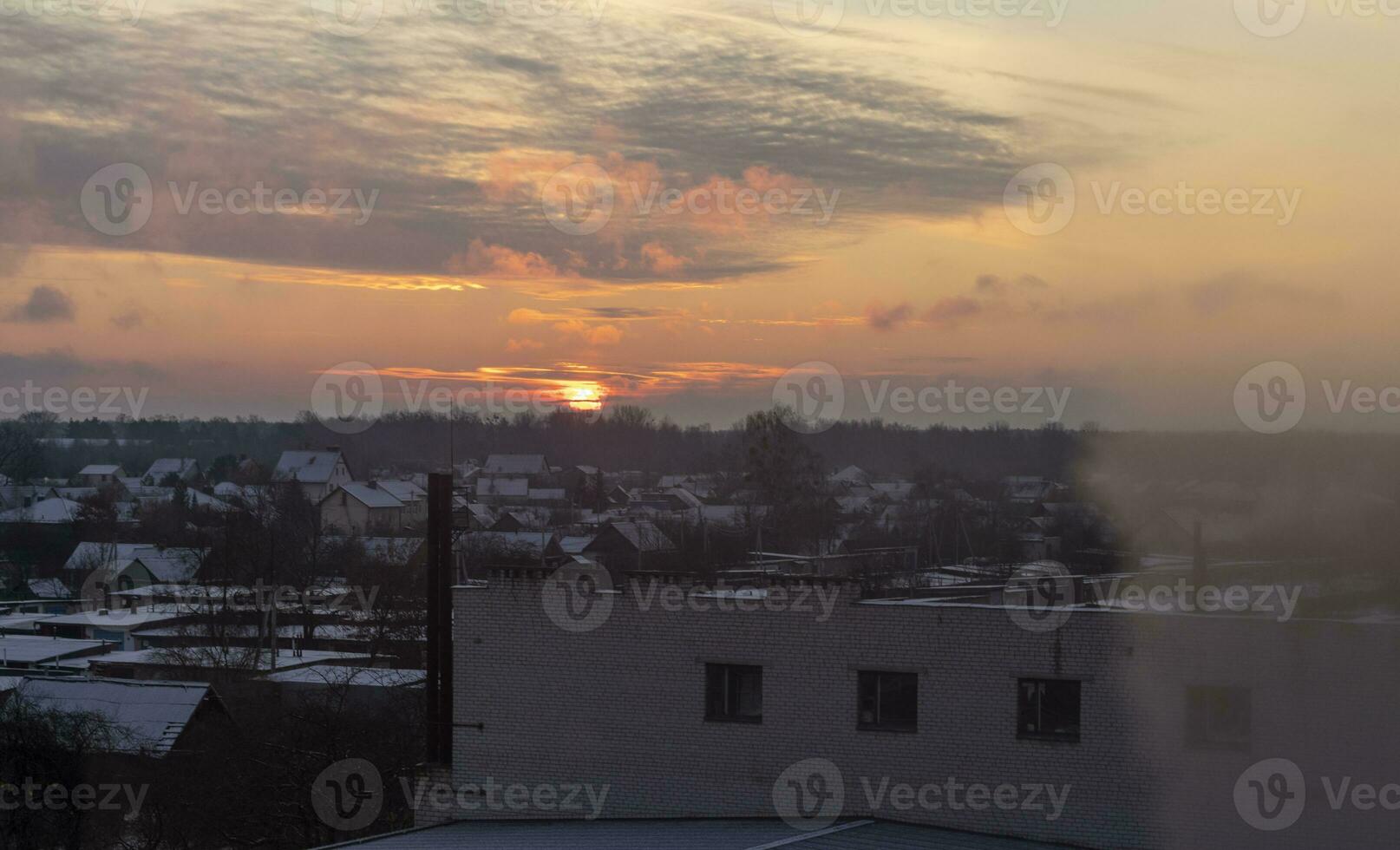 Shot of the dramatic sunset in the rural city in the cold morning. Season photo