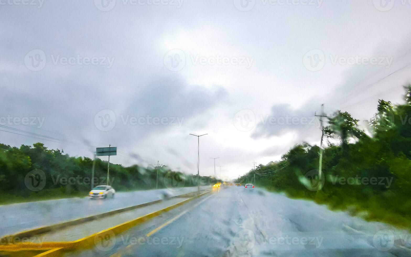 Driving on highway in car through tropical storm hurricane Mexico. photo