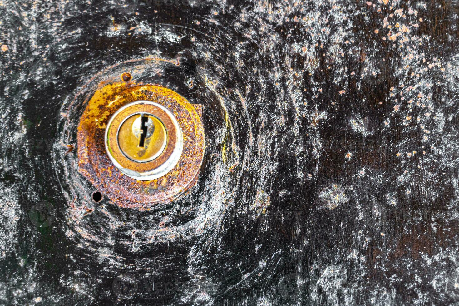 Rusted keyhole in metal door in Playa del Carmen Mexico. photo