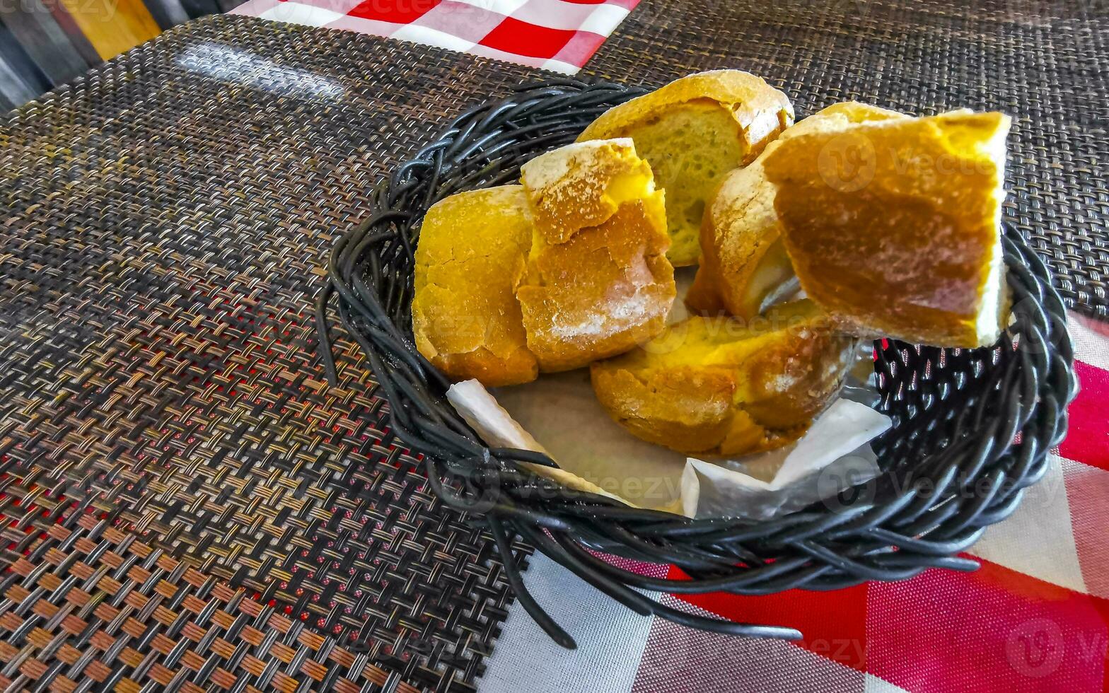 Bread in basket on wooden table vintage restaurant Mexico. photo