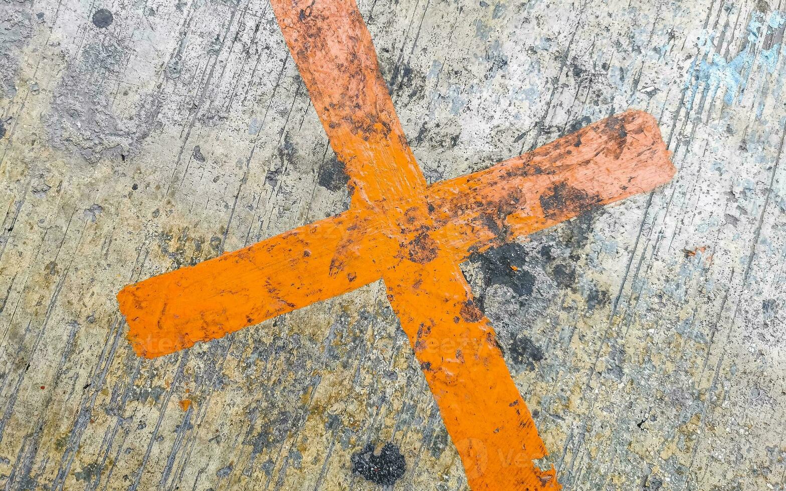 Orange painted cross on the sidewalk Playa del Carmen Mexico. photo