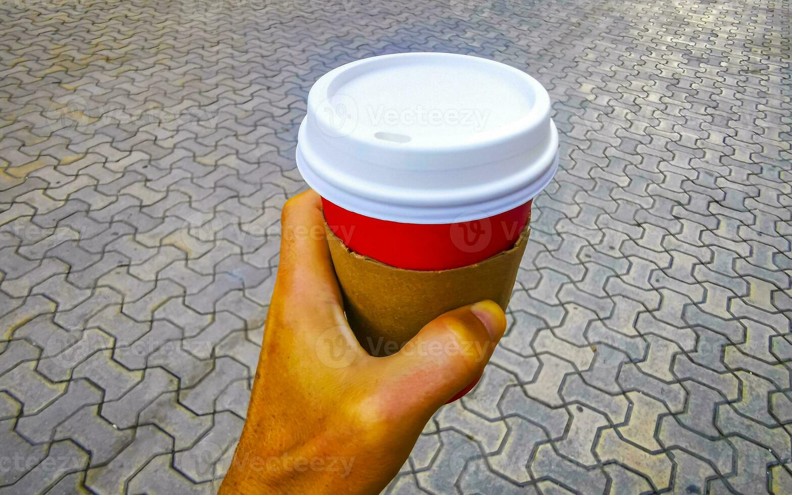Coffee to go paper cup in hand in city Mexico. photo