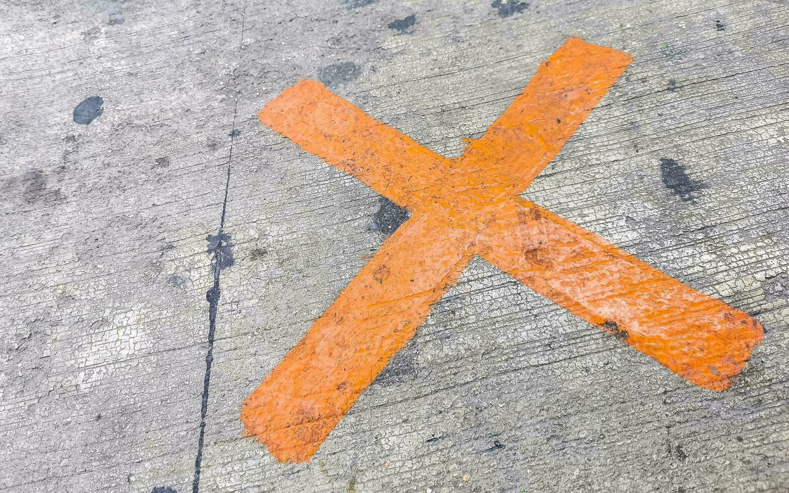 Orange painted cross on the sidewalk Playa del Carmen Mexico. photo