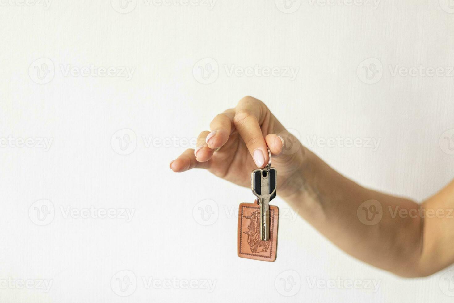 Close up shot of the woman's hand holding a key. Concept photo