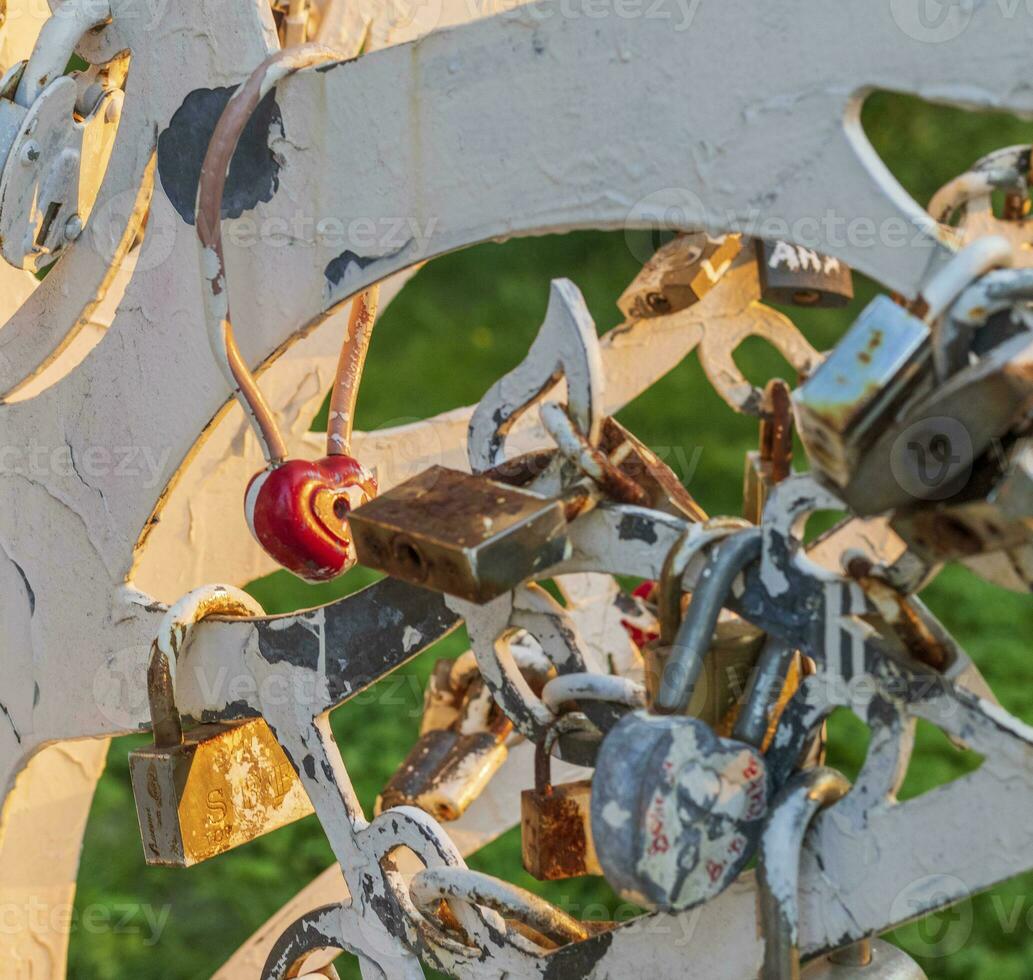 Metal structure where couples locking the locks as a sign of true love. Faith photo
