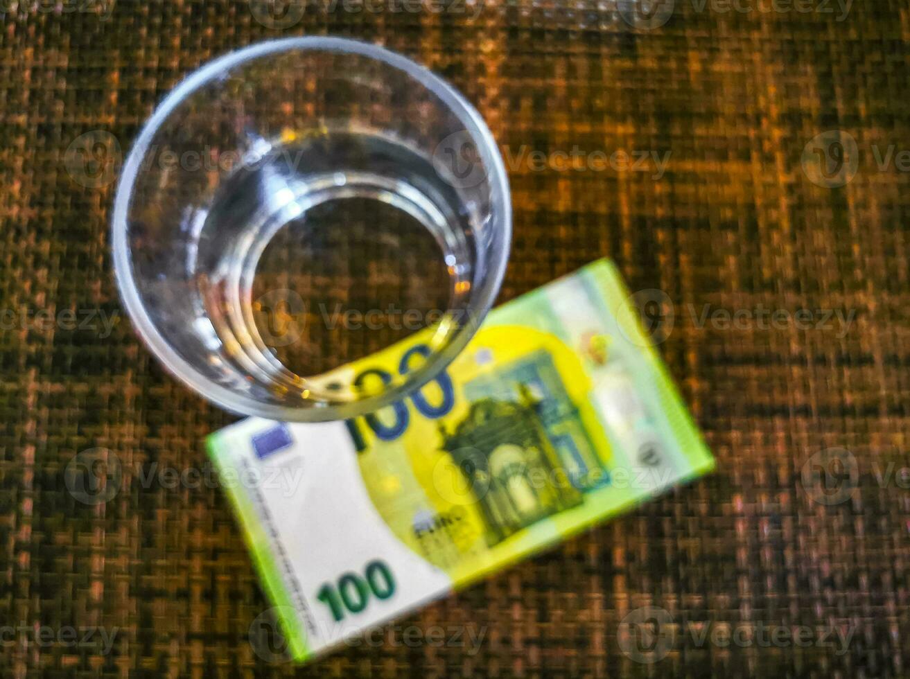 Large euro bill Money on table and glass of water. photo