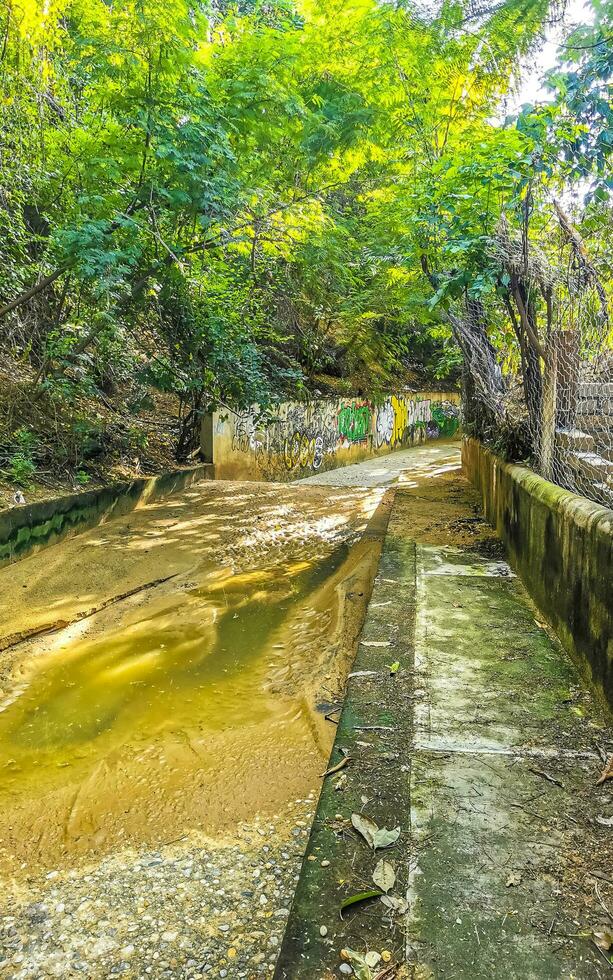 Puerto Escondido Oaxaca Mexico 2022 Open sewerage system in the tropical jungle mountains Mexico. photo