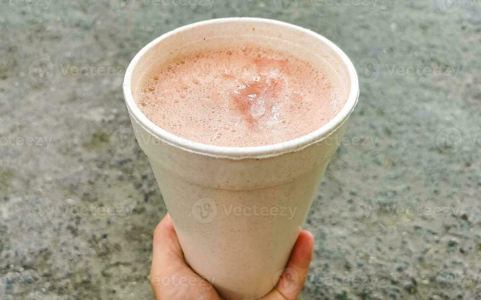 Pink juice smoothie in a takeaway cup Playa del Carmen. photo