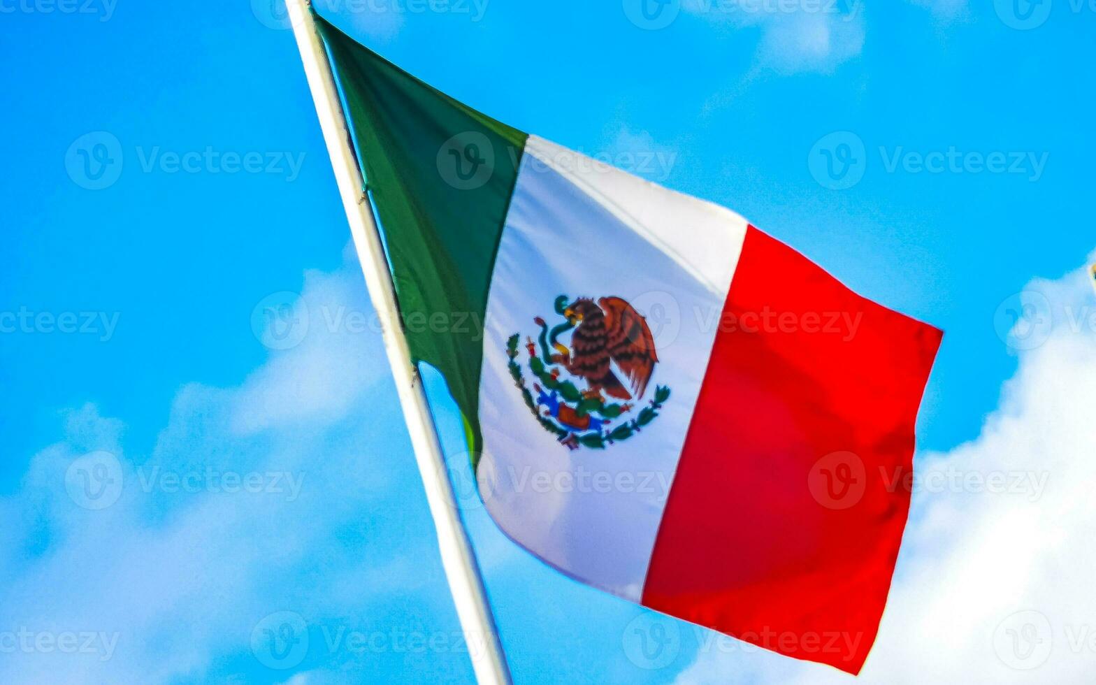 Mexican green white red flag with blue sky in Mexico. photo