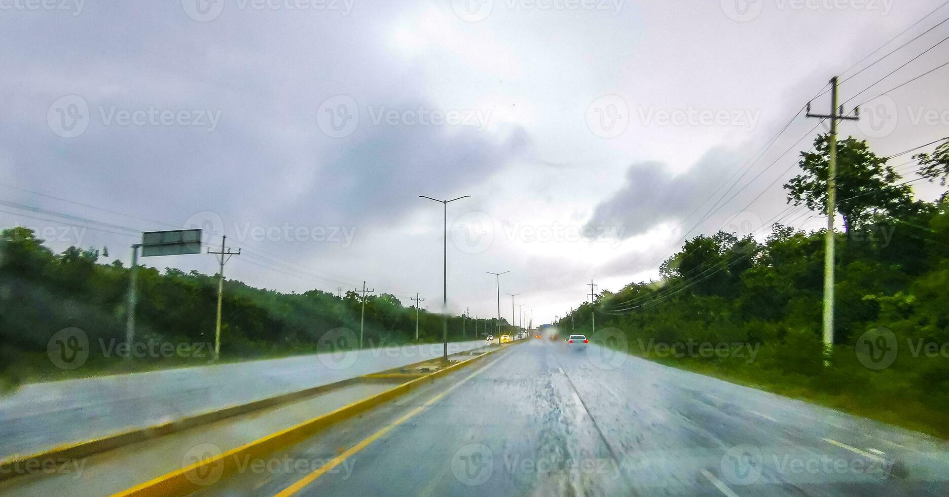 Driving on highway in car through tropical storm hurricane Mexico. photo