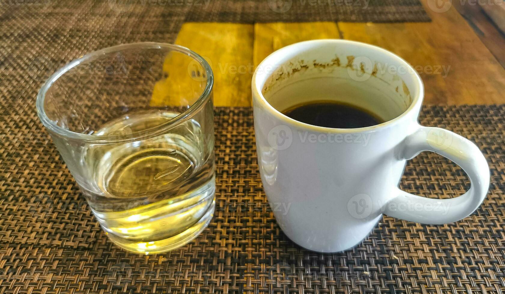 Cup of americano black coffee and glass of water cafe. photo