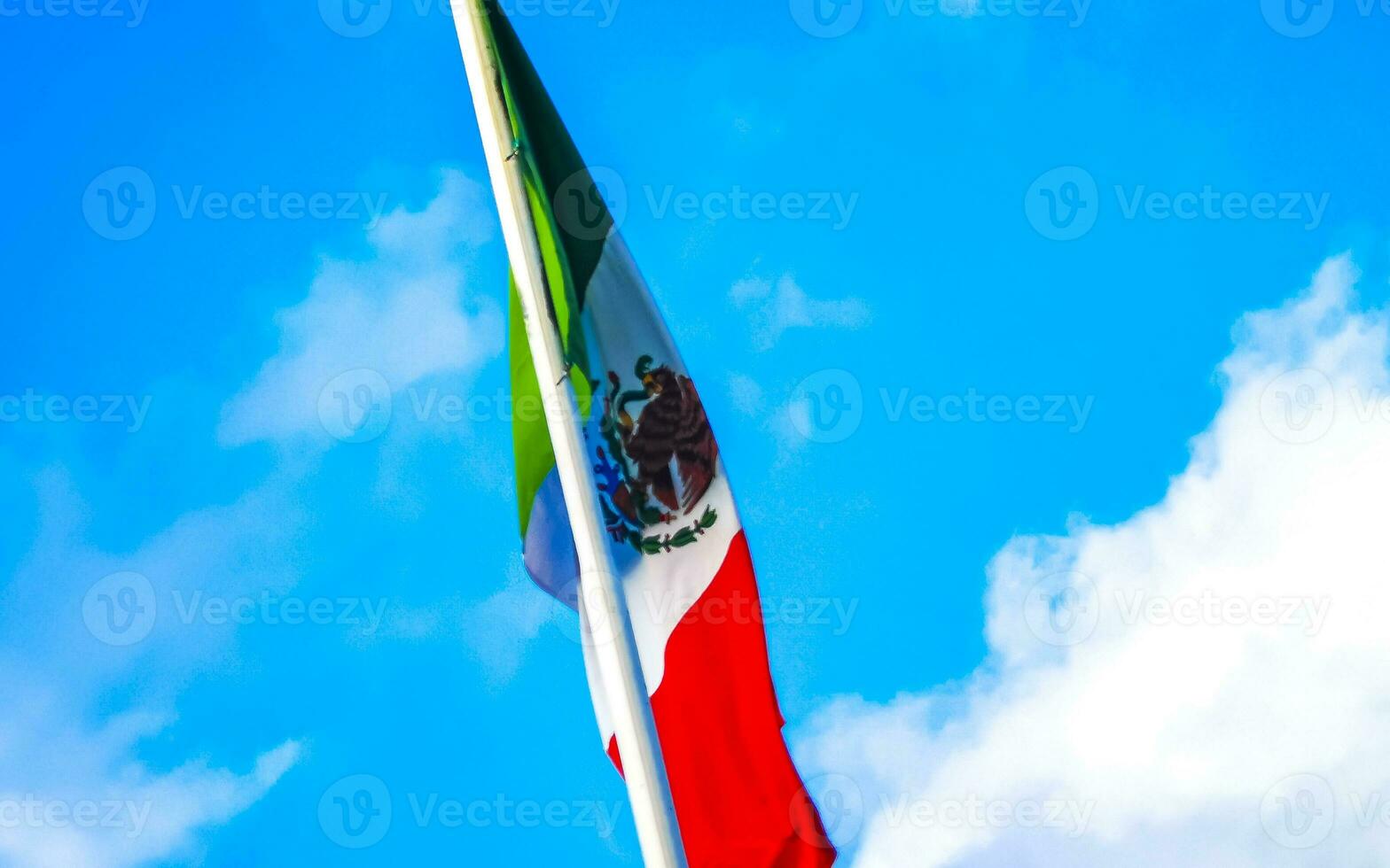 Mexican green white red flag with blue sky in Mexico. photo