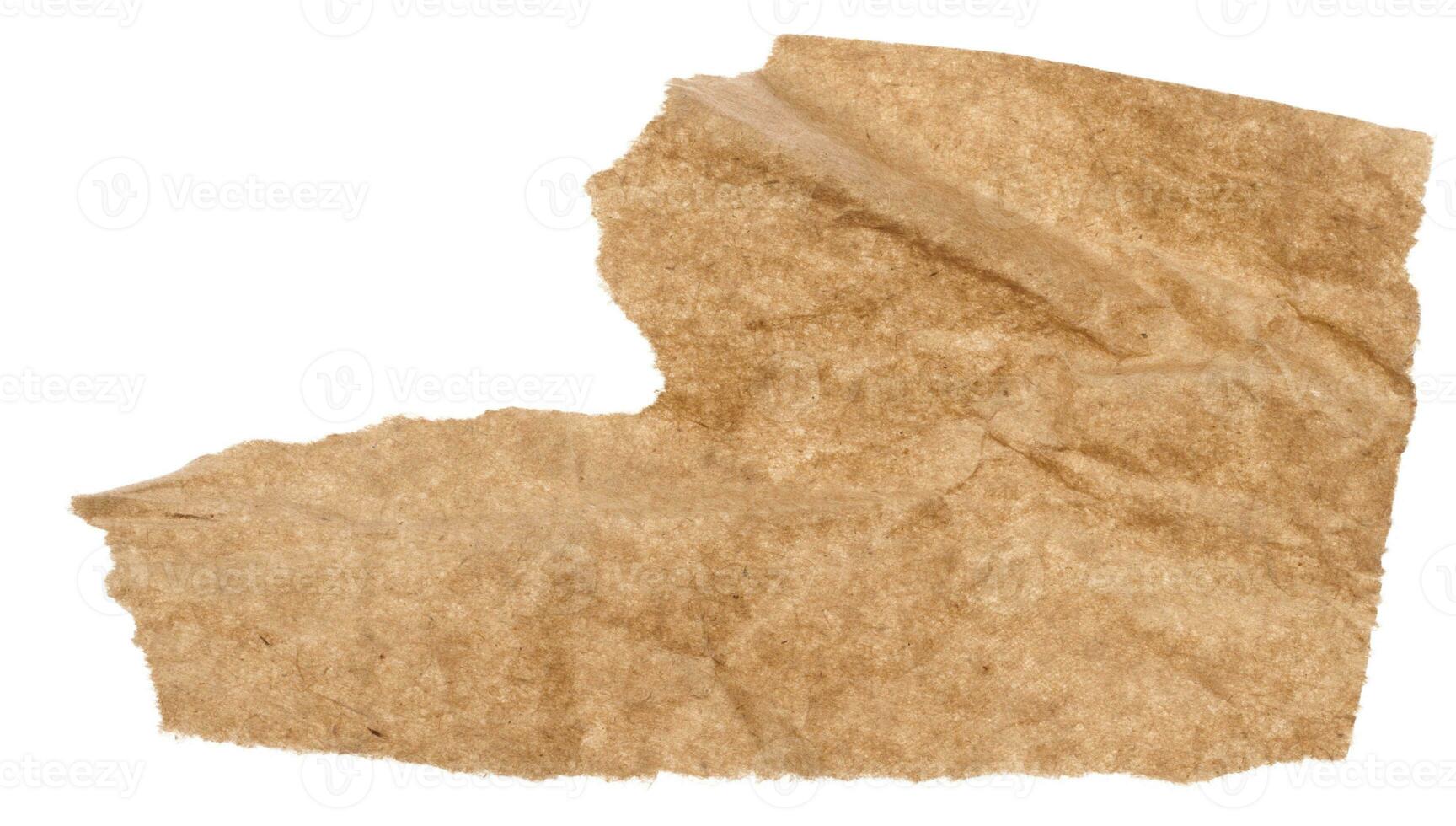 Piece of brown paper with torn edges isolated on background photo