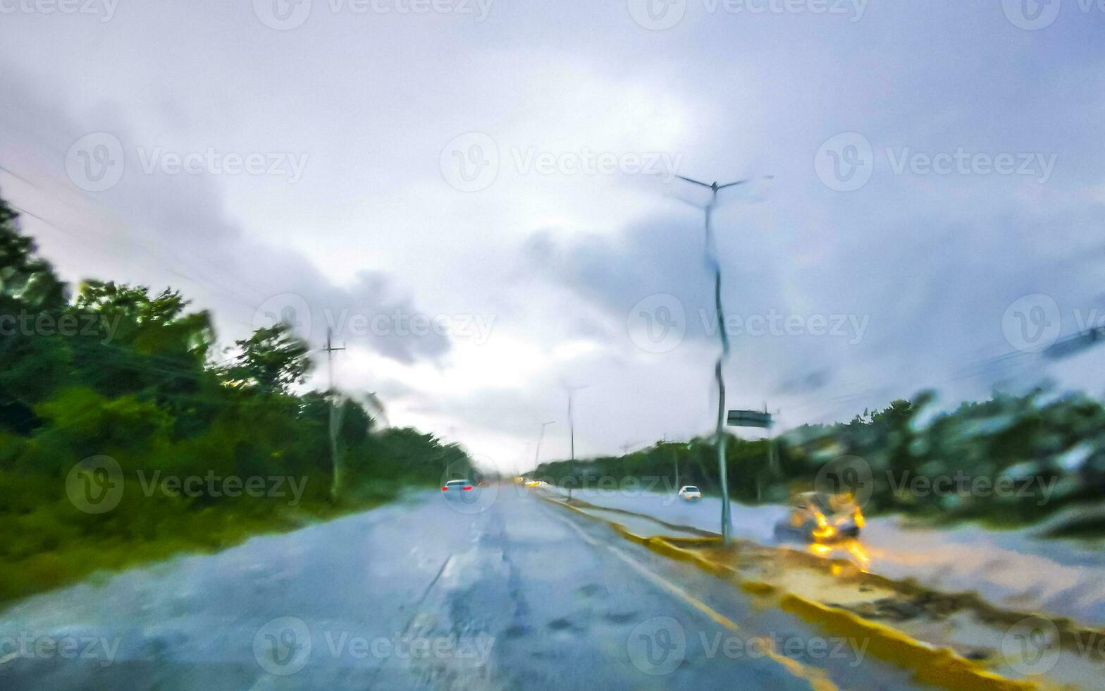 Driving on highway in car through tropical storm hurricane Mexico. photo