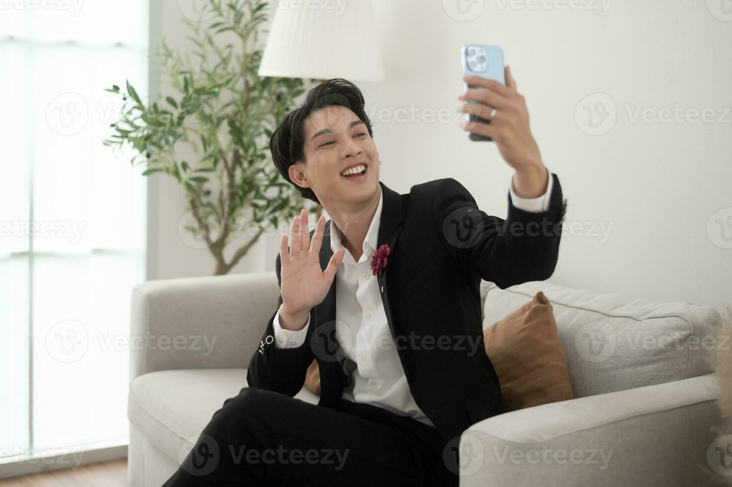 An asian groom using smartphone in wedding day concept of Wedding party photo