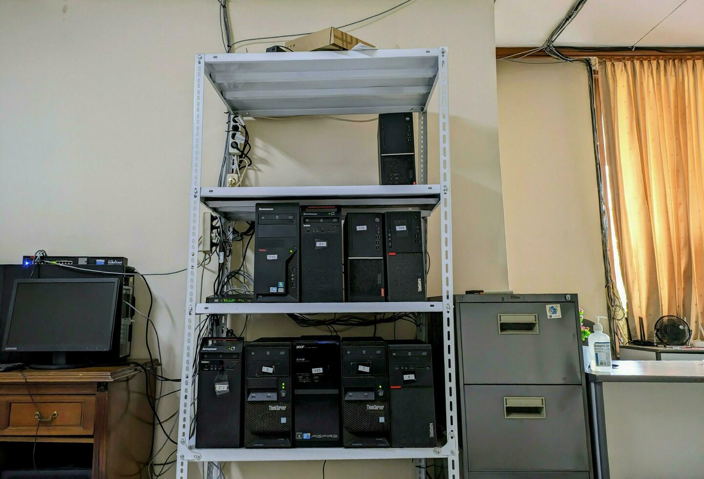 white server racks and PCs arranged on them photo