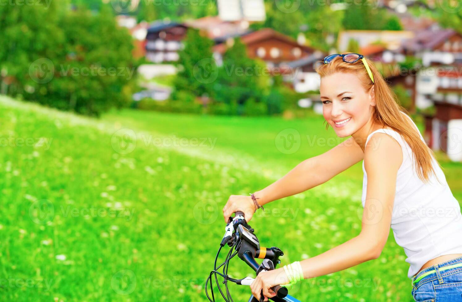 Sportive teen girl riding on bicycle photo