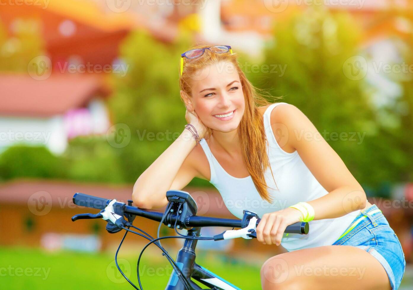 Happy woman on the bicycle photo