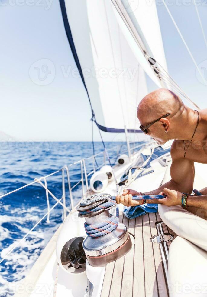 Handsome man on sailboat photo
