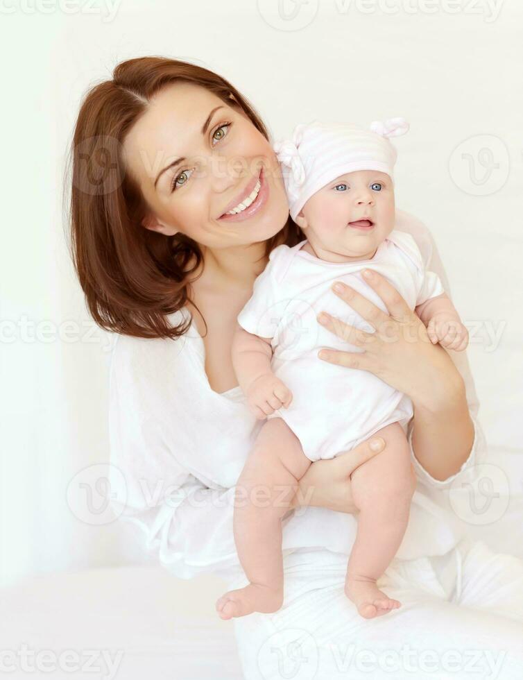 Cheerful mother with little baby photo