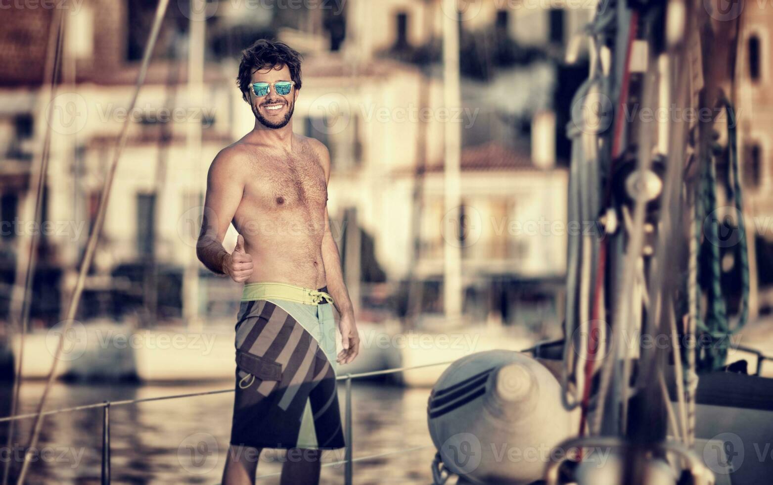 Happy man on the sailboat photo