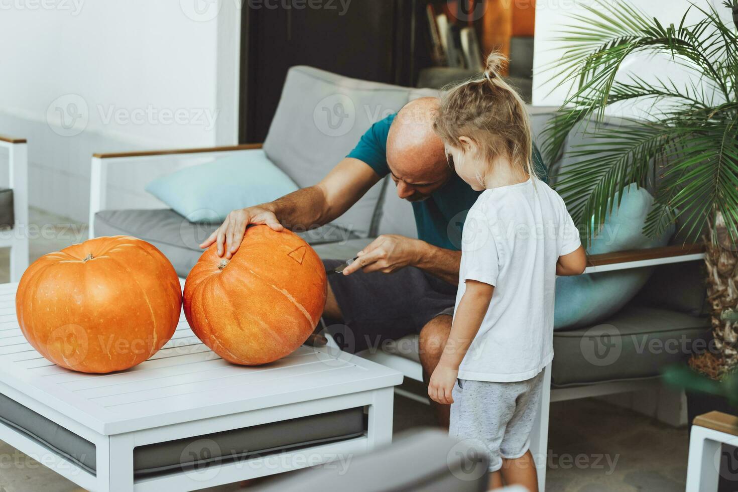 Happy family decorating for Halloween holiday photo