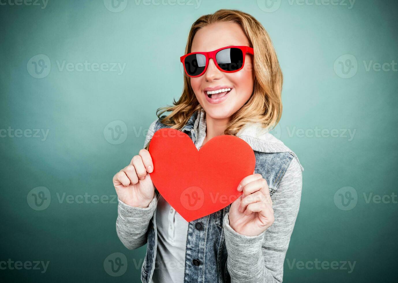 Cheerful female with paper heart photo