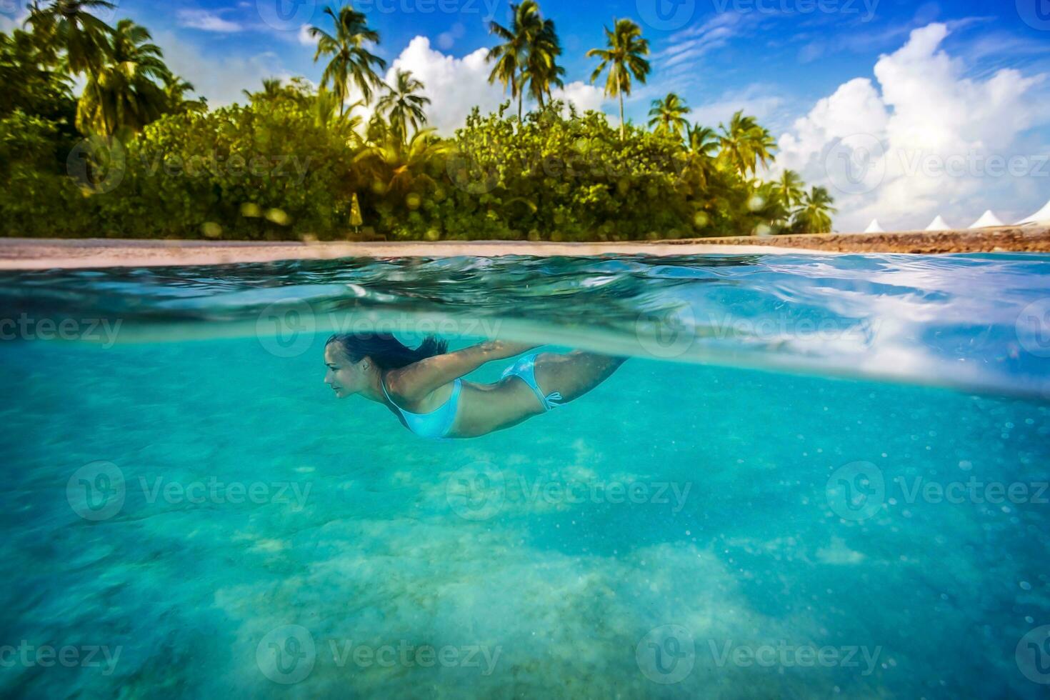 Woman swimming underwater photo