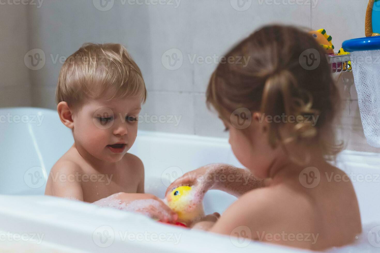 Happy kids taking bubble bath photo