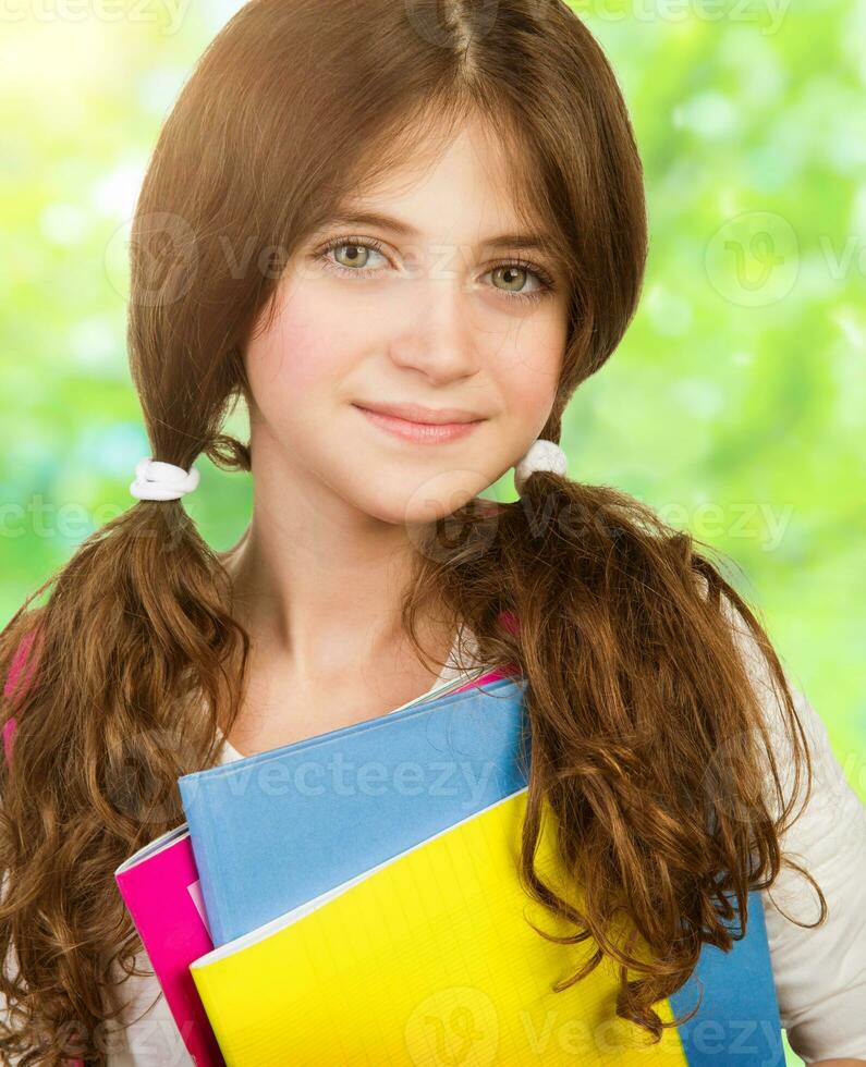 Schoolgirl portrait with books photo